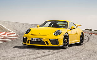 yellow Porsche 911 on road at daytime