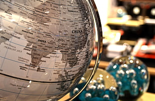 shallow focus photograph of gray table globe
