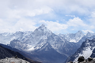 photo of snow mountains and cloudy sky during day time