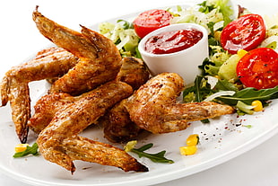 food photography of fried chicken wings with sauce served on white plate