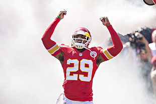 football player raising two hands