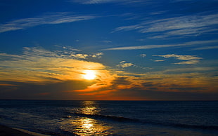 body of water during sunset