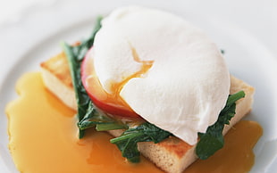 closeup photo of cooked food with green garnish served on plate