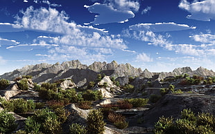 rocky mountain under white and blue clouds