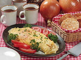 pasta with tomatoes served on plate near wicker basket with flat breads