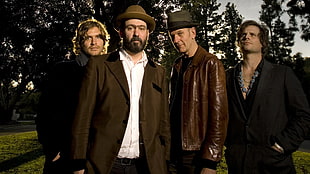 four men wearing black and brown coats HD wallpaper
