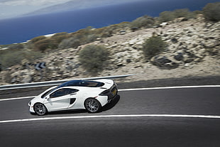 white McLaren 650s on asphalt road