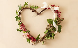 green and white floral heart-shaped wreath hanged on wall