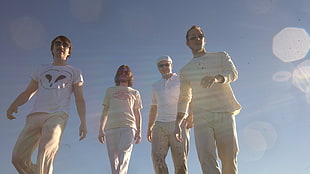 four person standing during daytime