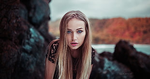 focus photography of woman wearing black shirt in front of rocks HD wallpaper