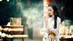 female holding stick while praying facing jar HD wallpaper