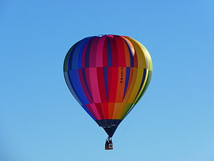 blue, red, and yelow hot air ballon on air
