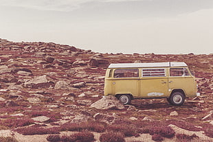 van on rocky field during daytime