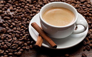 coffee in white ceramic cup with saucer