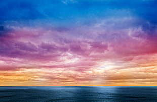 landscape photo of rainbow-colored clouds