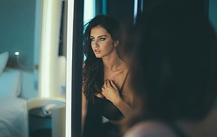woman wearing black brassiere in front of mirror in room HD wallpaper