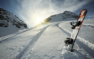 orange and black snowboard with bindings, snow, mountains, snowboards