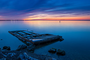 brown wooden frame on body of water