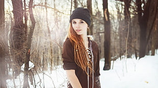 woman wearing brown jack near trees during daytime