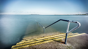 brown and yellow concrete dock with black handrail, dublin, ireland