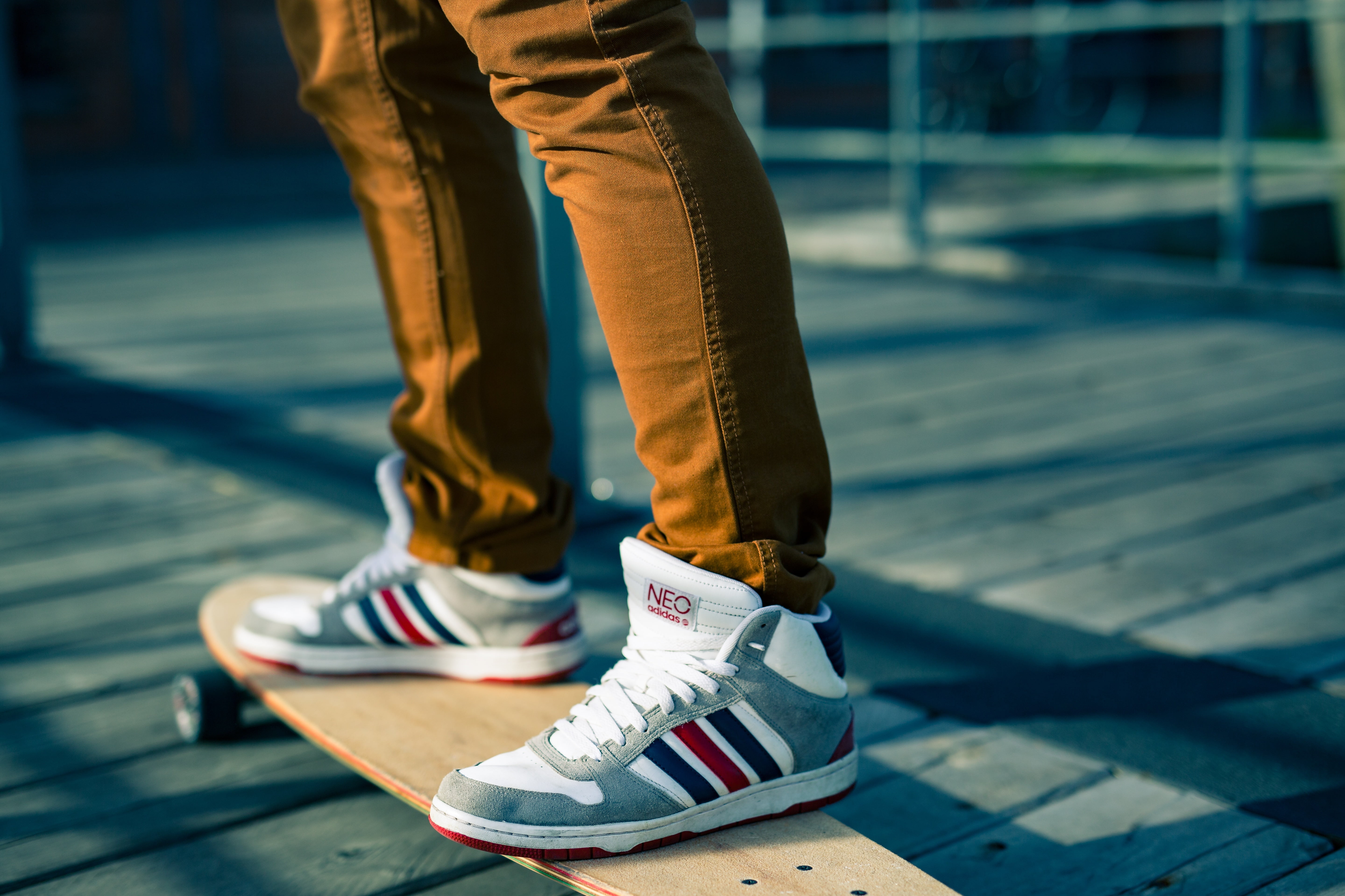 Selective focus photography of Adidas Neo sneakers with brown longboard HD  wallpaper | Wallpaper Flare