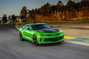 green Chevrolet Camaro on road time lapse photography HD wallpaper