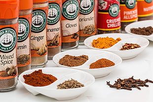 assorted spices on white ceramic plates on white table