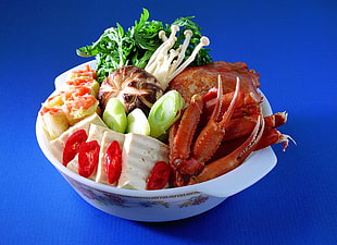 raw food with vegetable served on white bowl