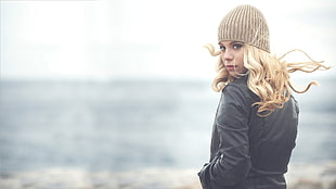woman wearing jacket standing beside beach HD wallpaper