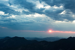 silhouette of mountain during sunset photography