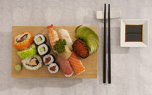 varieties of sushi beside black chopsticks HD wallpaper