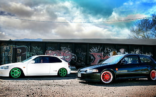 white and black 3-door hatchbacks on gray concrete road