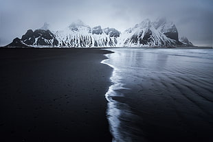 rock formation beside body of water