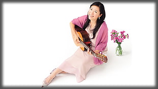 woman wearing pink dress with cardigan playing brown guitar HD wallpaper