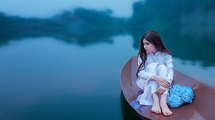 woman in white robe on brown boat raft on top of body of water HD wallpaper