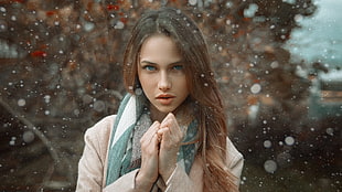 woman wearing brown coat with green scarf during winter