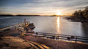 sunrise view from dock near body of water, finland