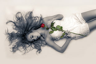 woman wearing strapless dress holding red rose lying on surface HD wallpaper