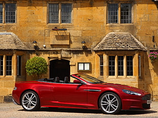 red coupe beside brown building during daytime HD wallpaper