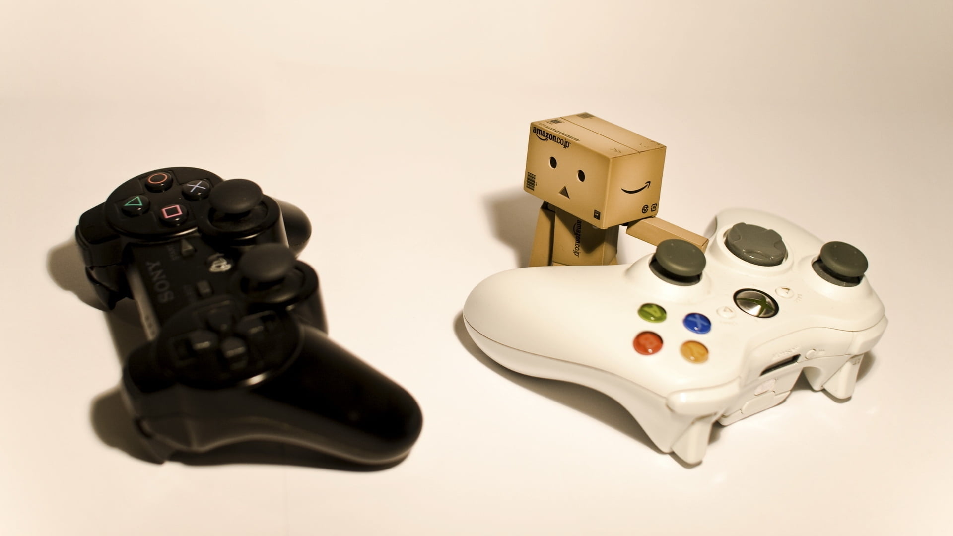 Black Sony PS3 controller and white Xbox 360 controller with carton robot  HD wallpaper | Wallpaper Flare
