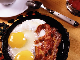 cooked bacon and egg on a black frying pan HD wallpaper