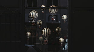 black wooden 4-tier shelf, hot air balloons, window, globes