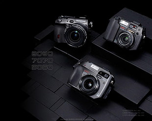 black Olympus 8080, 7070, and 5050 compact cameras HD wallpaper