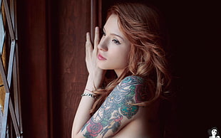 woman with green and red flower arm tattoo HD wallpaper