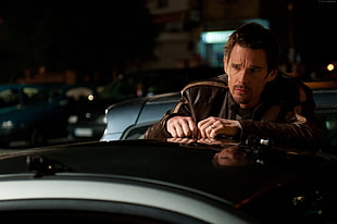 man wearing black leather jacket standing near black car movie character HD wallpaper