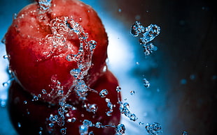 selective photo of red apple fruit with splashed of water HD wallpaper