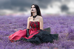 woman wearing red and black strapless dress