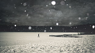 man walking on snow covered field HD wallpaper