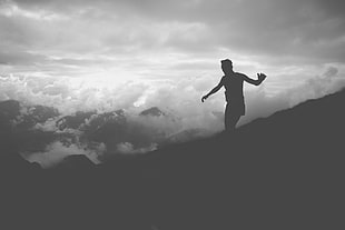 silhouette of man overlooking cloud and mountain HD wallpaper