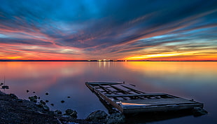 photo of brown wooden flat-bed floater on body of water during dawn time, lavonia